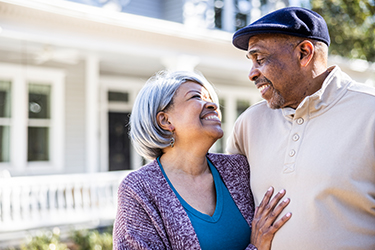 Woman and man smiling and looking at each other